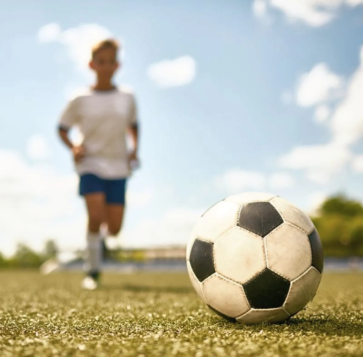 Children playing football outdoors