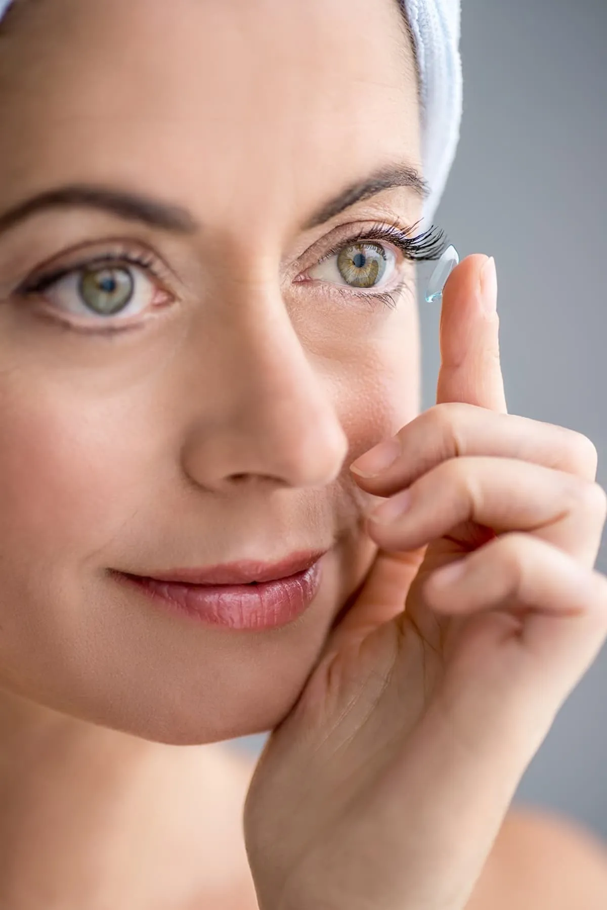 Woman inserting contact lens