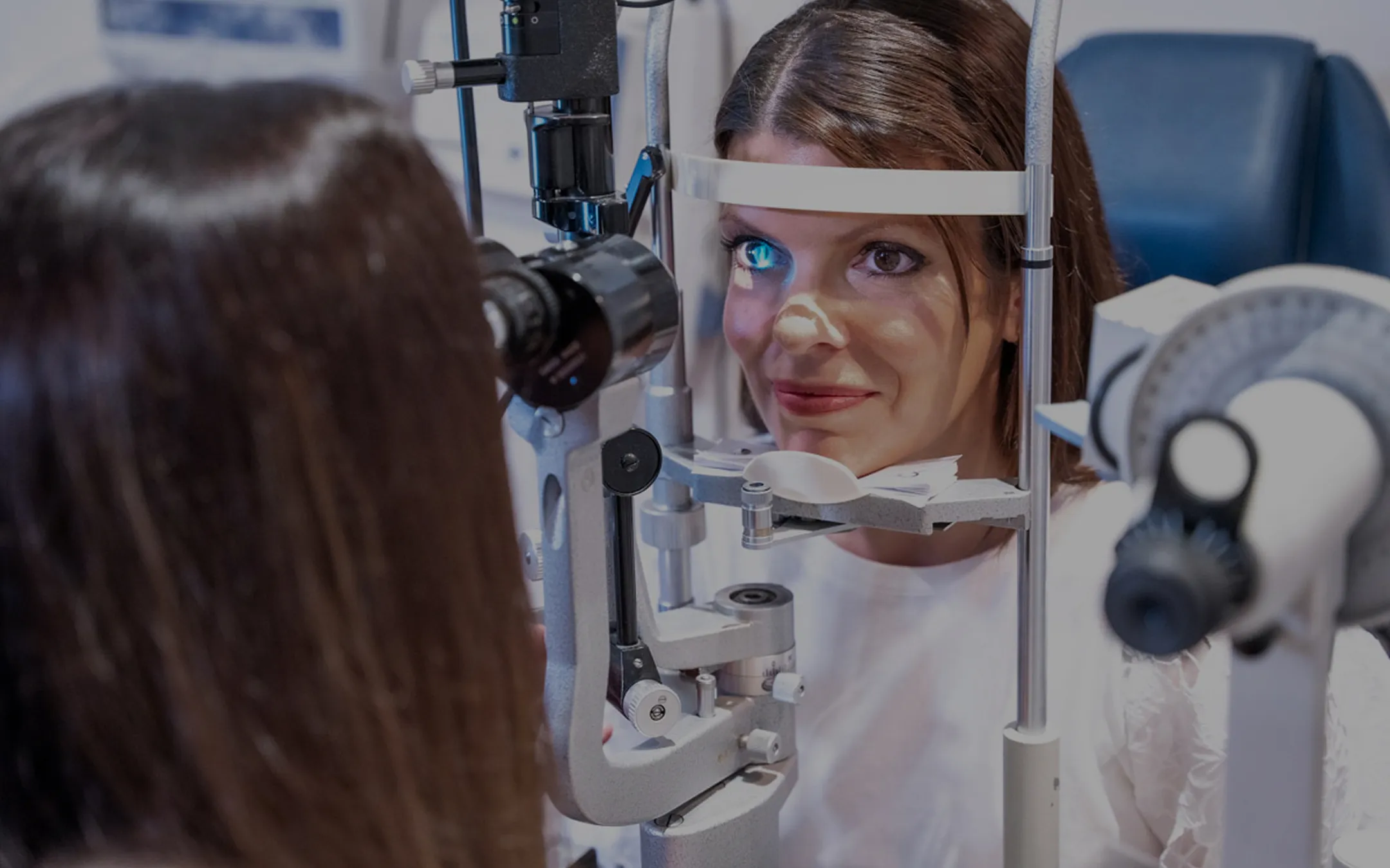 Female patient undergoing slit lamp eye examination at David C. Henderson Opticians