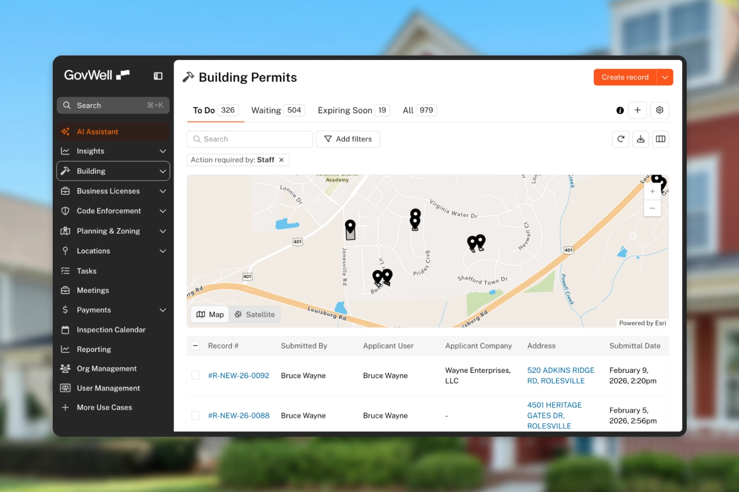 GovWell dashboard showing building permits with a map highlighting locations and a table listing permit records submitted by Bruce Wayne.