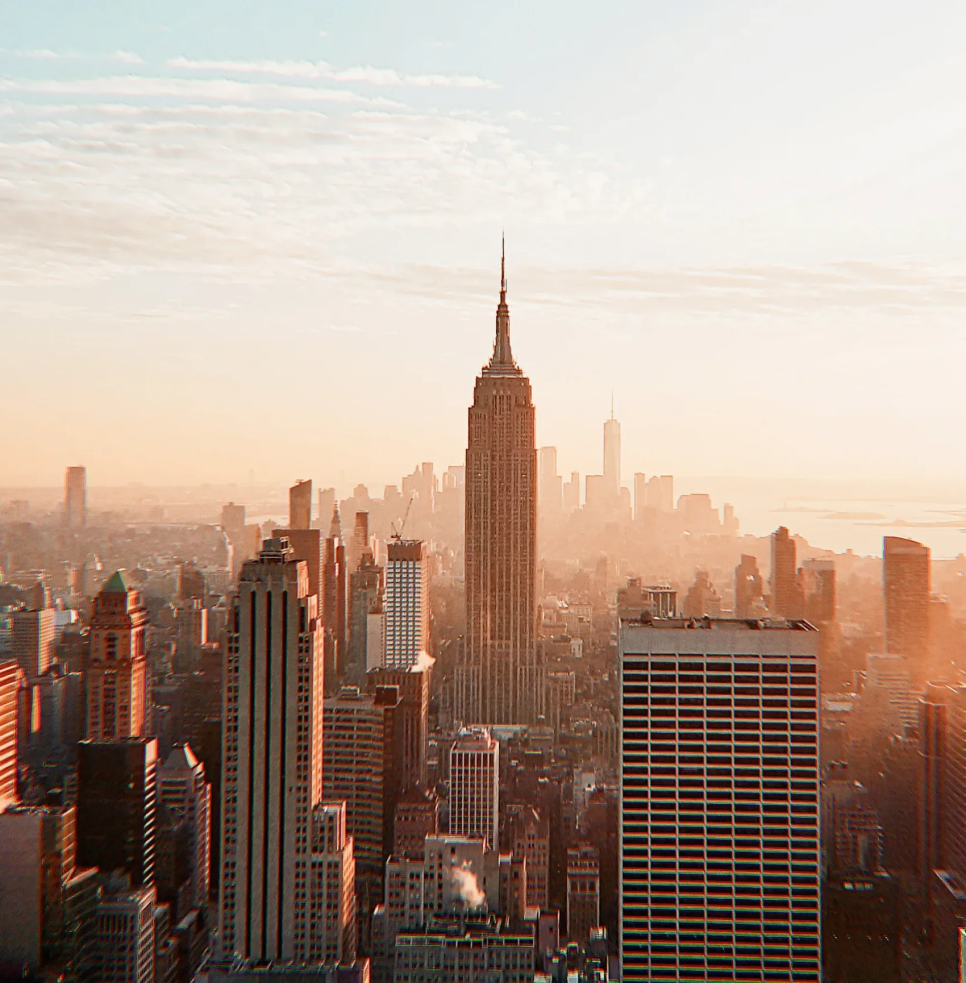 Sunset aerial view of New York City skyline centered on the Empire State Building.