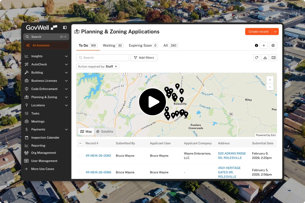 GovWell dashboard showing building permits with a map highlighting locations and a table listing permit records submitted by Bruce Wayne.