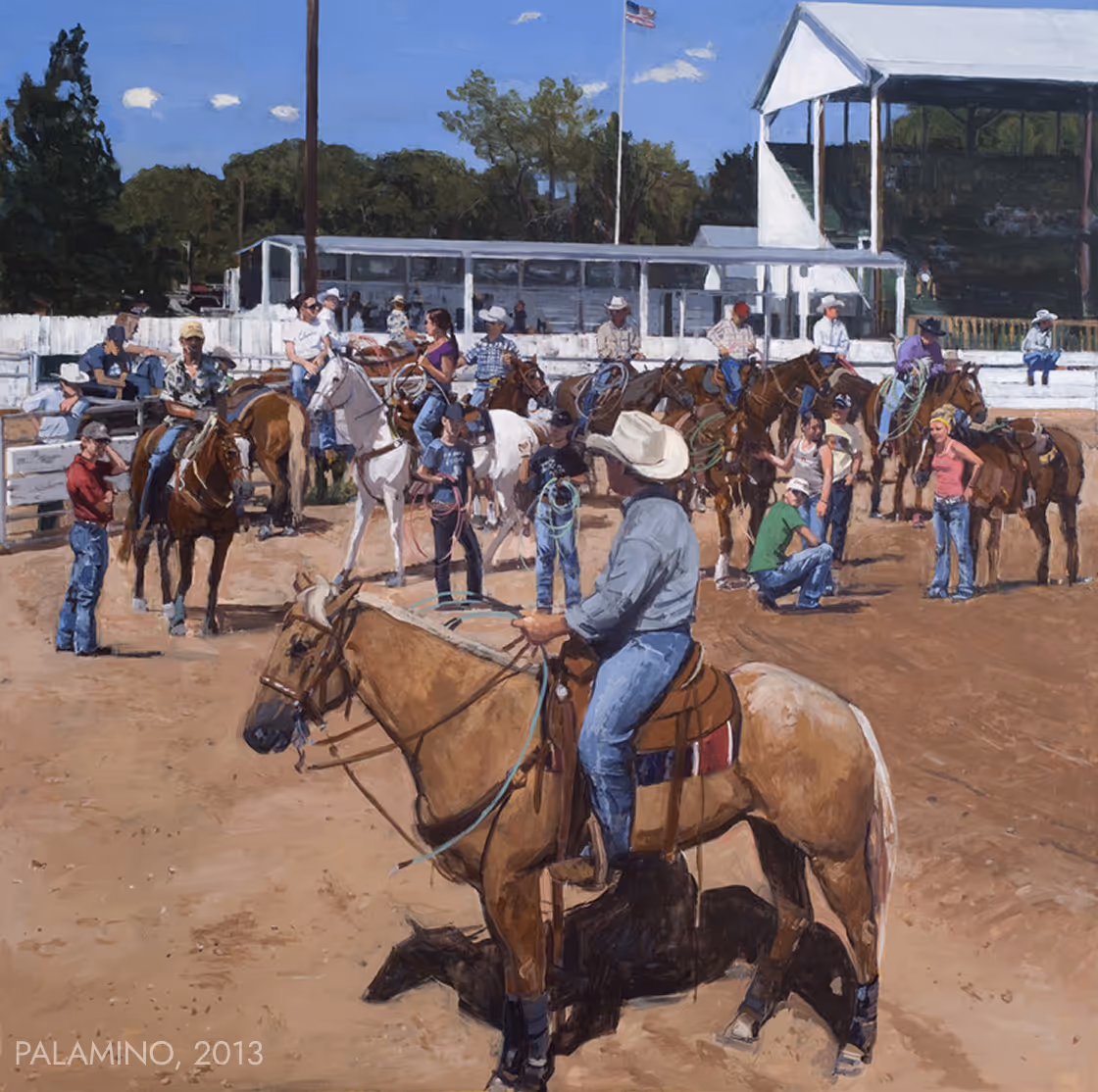 Group of people on horseback and standing in a rodeo arena with grandstands and an American flag.