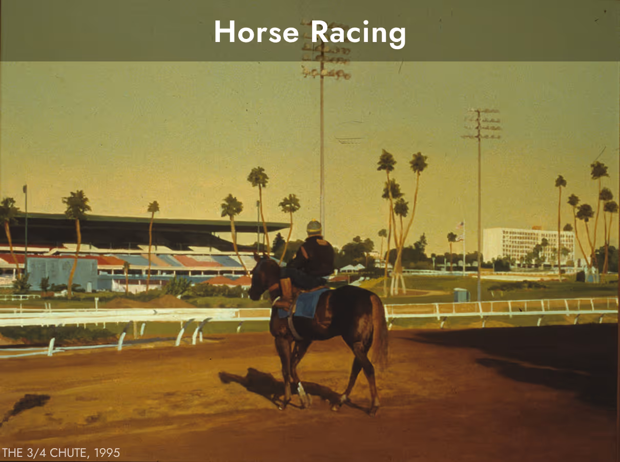 Jockey riding a horse on a racetrack at The 3/4 Chute with a grandstand and palm trees in the background.