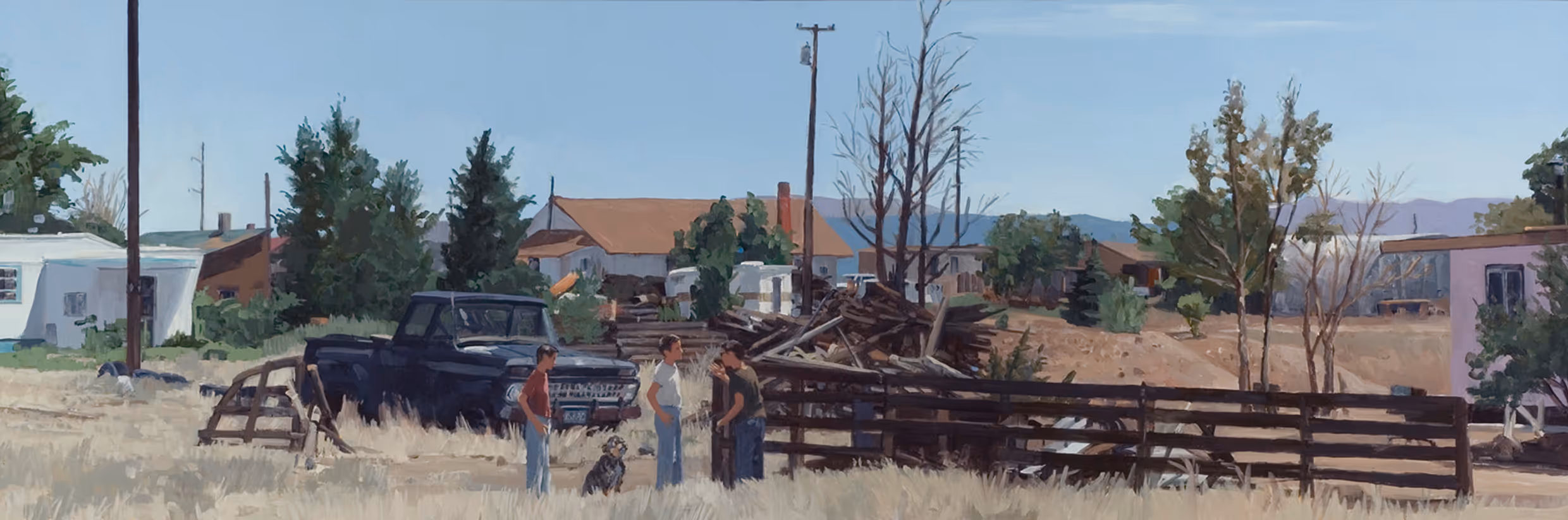 Three boys and a dog near an old truck and wooden fence in a rural neighborhood.