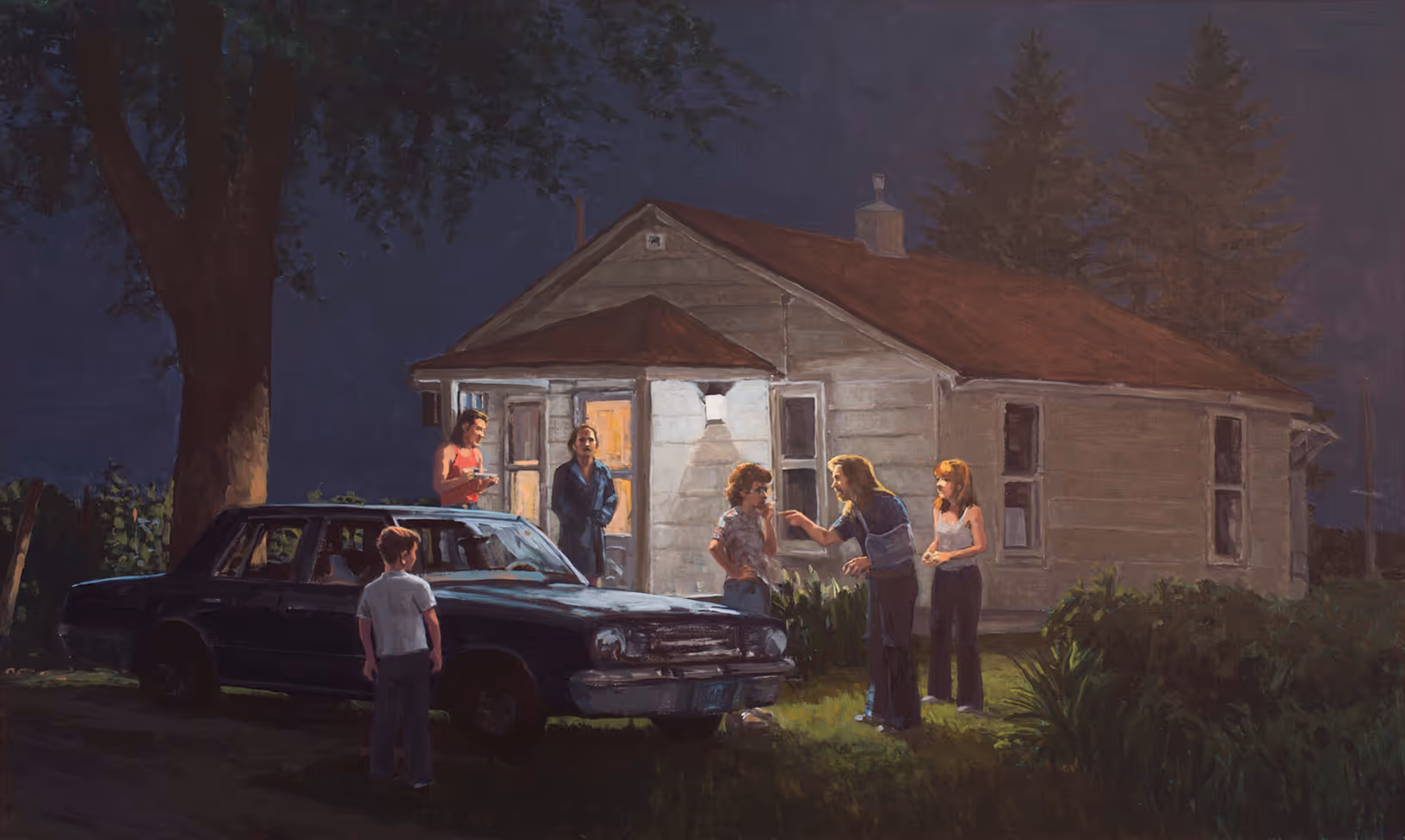 Six people gather outside a lit house at night near a parked car under a large tree.
