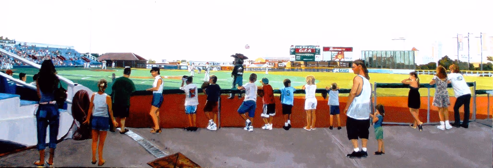 Children and adults watching a baseball game from behind a fence near the first base line.
