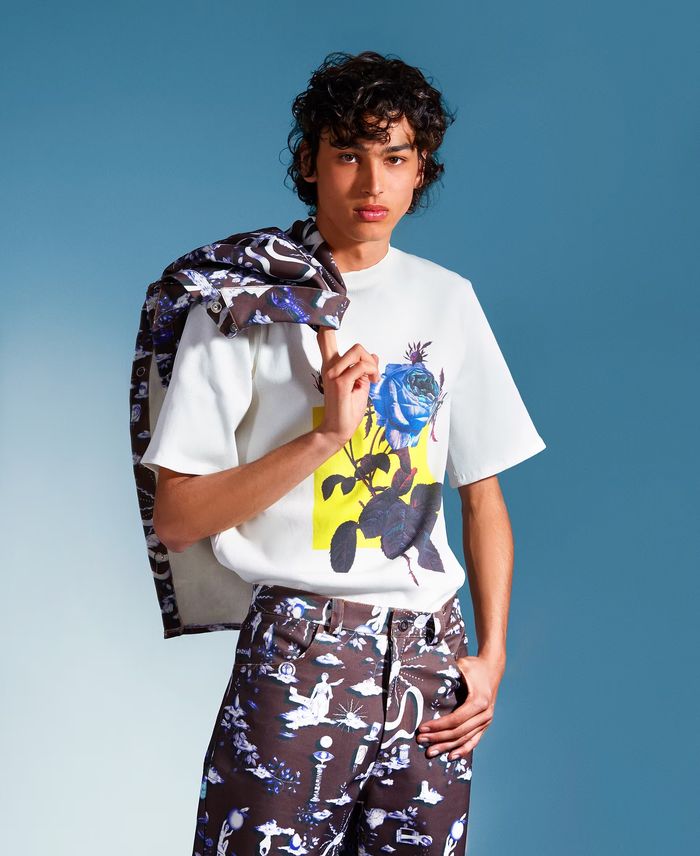 Model in blue seen through layers of moving fabric