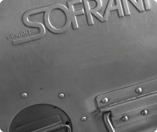 Close-up of a metallic surface with embossed text 'SOFRANI' and 'Export' near rivets and a handle.