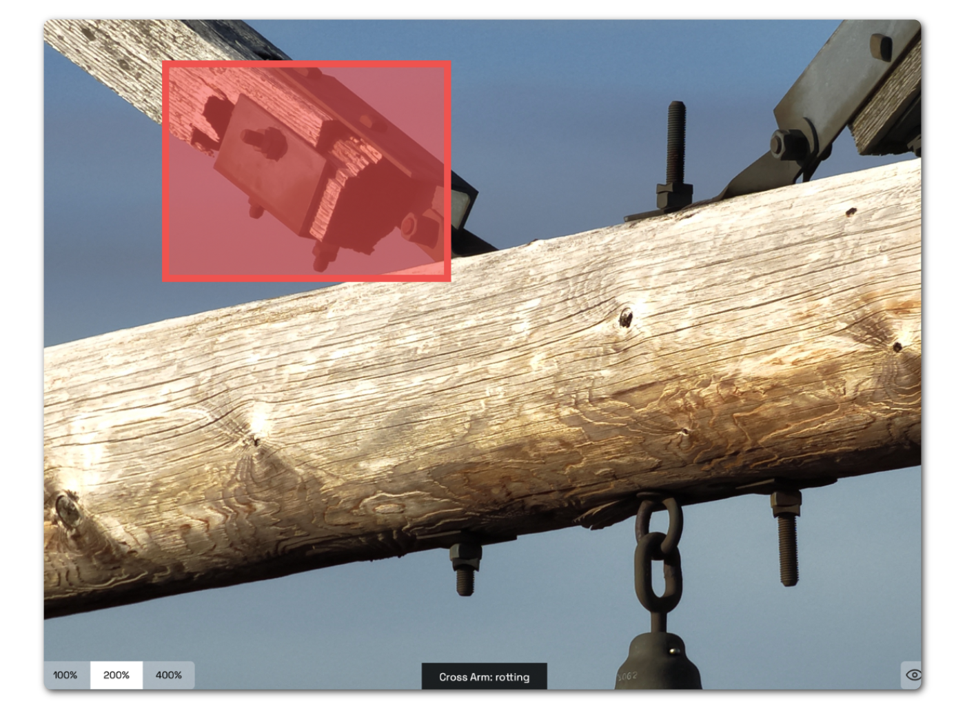 Close-up image of wooden H-frame cross-arm with visible rot, highlighted during drone inspection.