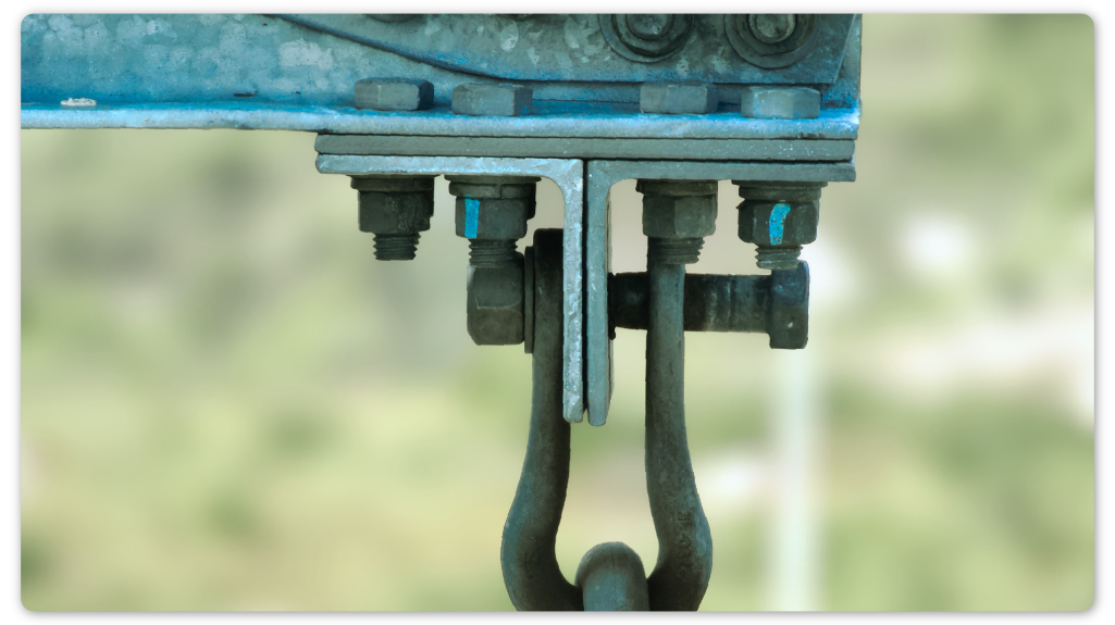 Close-up of transmission hardware showing loose clevis bolt detected during drone inspection.