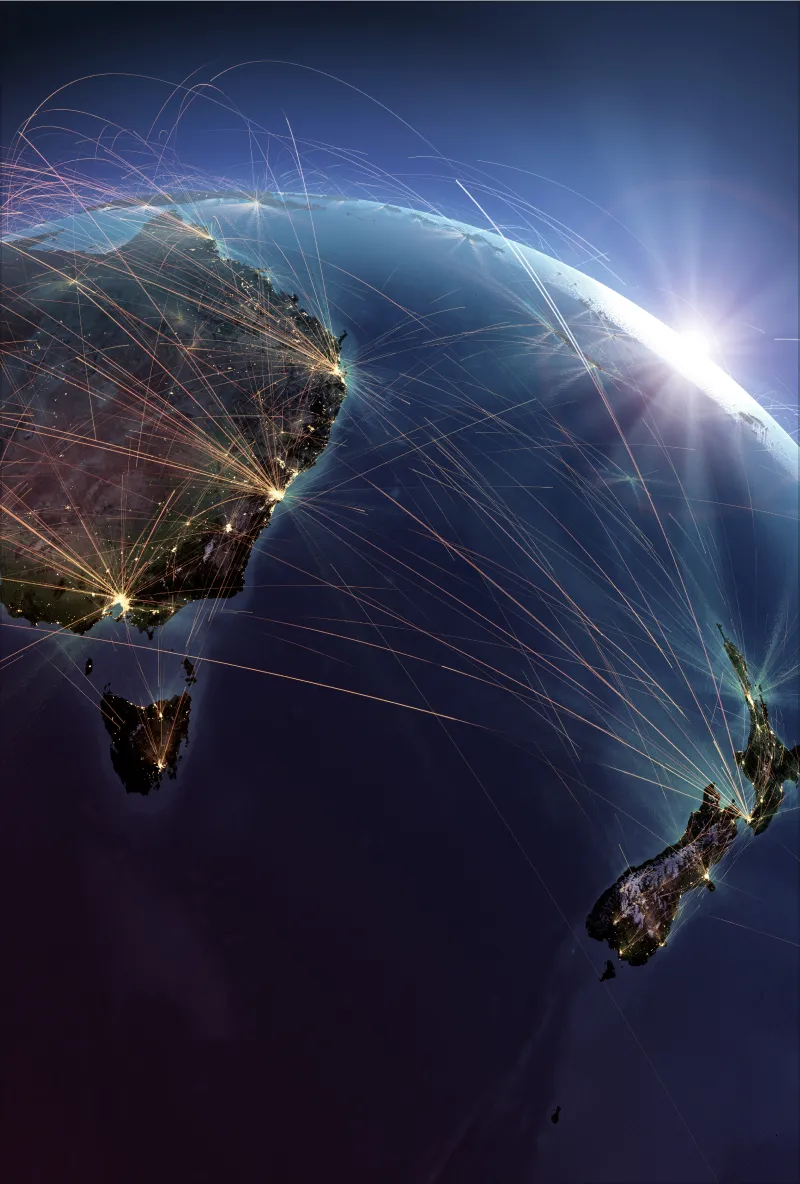 Satellite view of Earth at night showing Australia, Tasmania, and New Zealand connected by glowing network lines representing global communication or data flow.