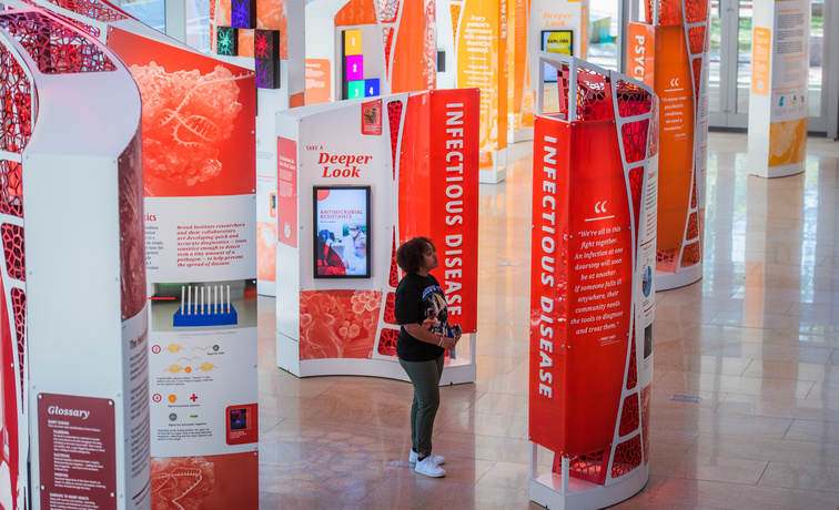 A digital exhibit screen displaying interactive content regarding infectious diseases. The display is part of a unified system that handles complex playback and real-time user feedback.