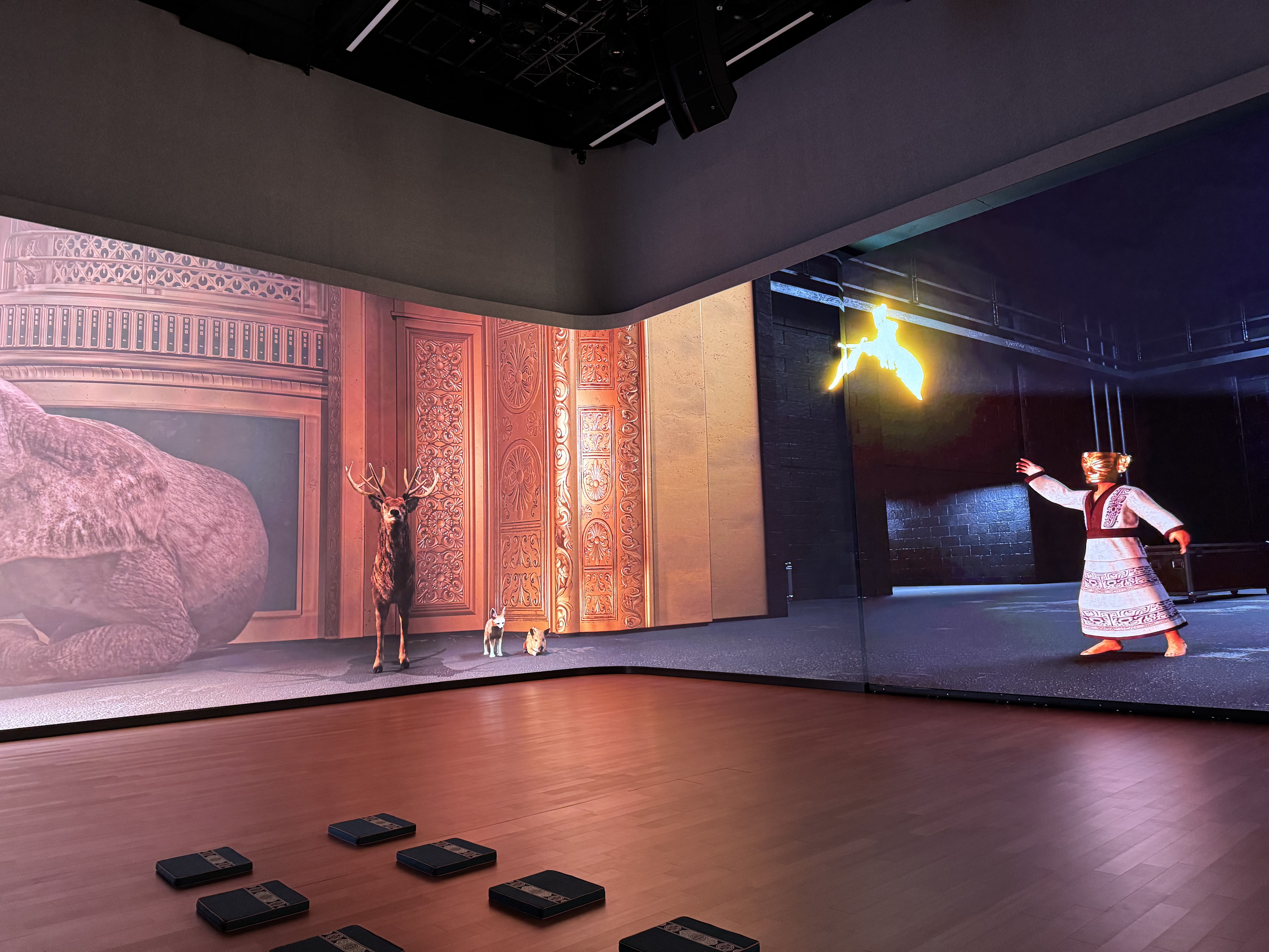 A wide view of the custom wraparound screen on screen, displaying cinematic media that demonstrates the scale of the integrated visual system.