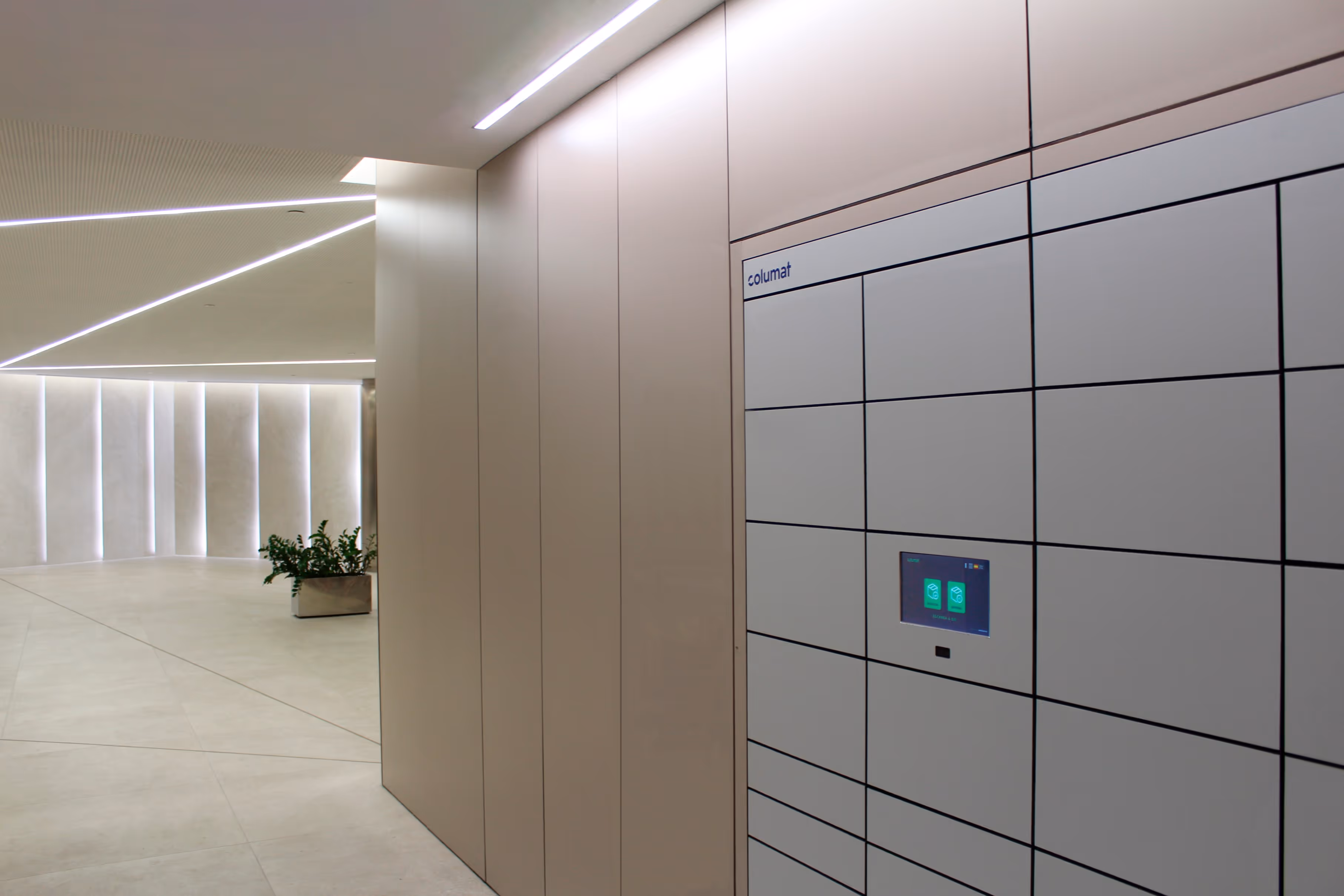 Modern office hallway with beige lockers and a digital smart locker system panel on the right wall.