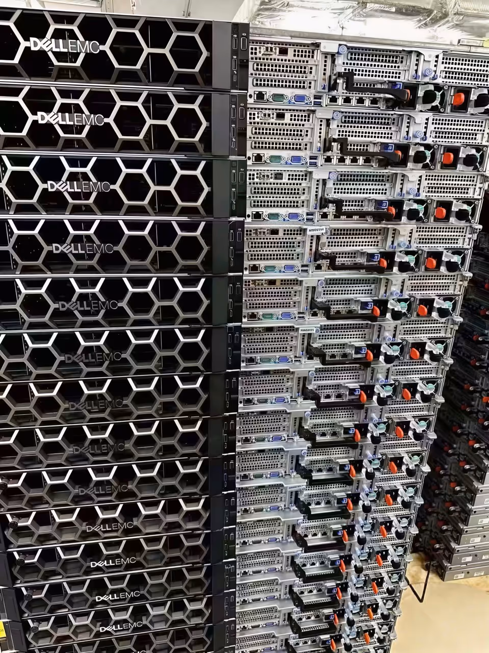 Rack of Dell EMC servers with a honeycomb front panel design in a data center.
