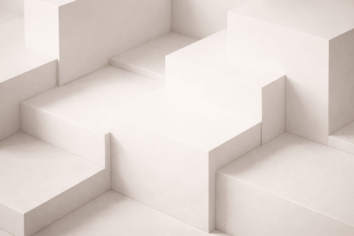 Minimalist close-up of smooth, light-colored geometric blocks arranged in a stepped pattern.