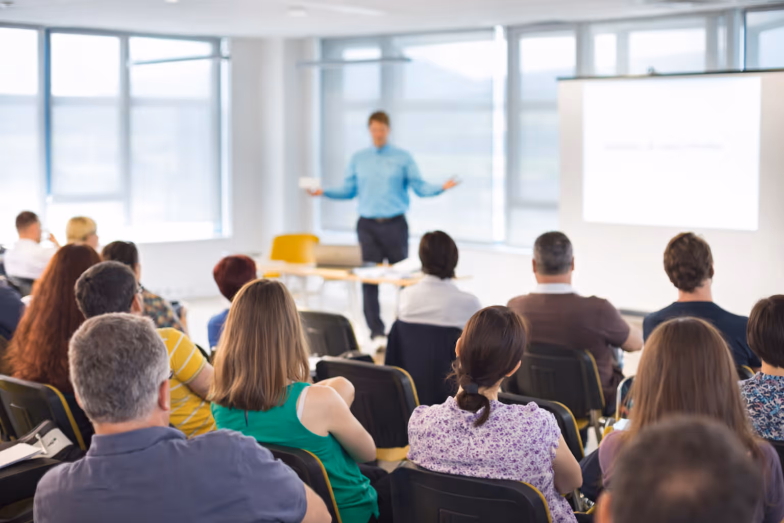 Many people are discussing the project in a meeting.