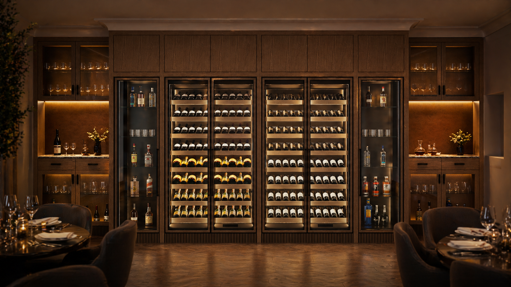 Integrated run of wine cabinets in dark timber restaurant joinery, with illuminated bottle display and dining tables in the foreground