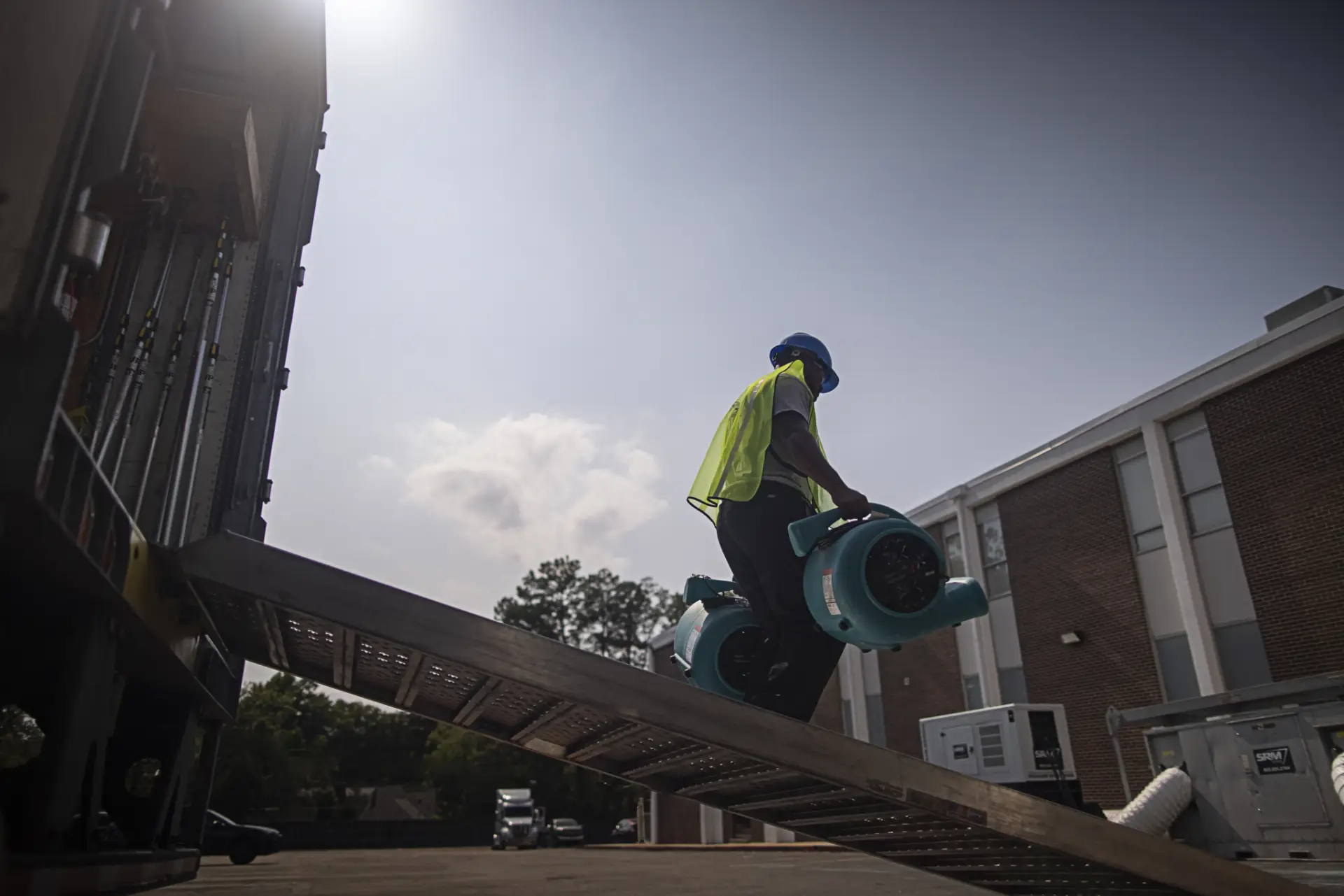 ServiceMaster technician unloading drying equipment for a commercial restoration