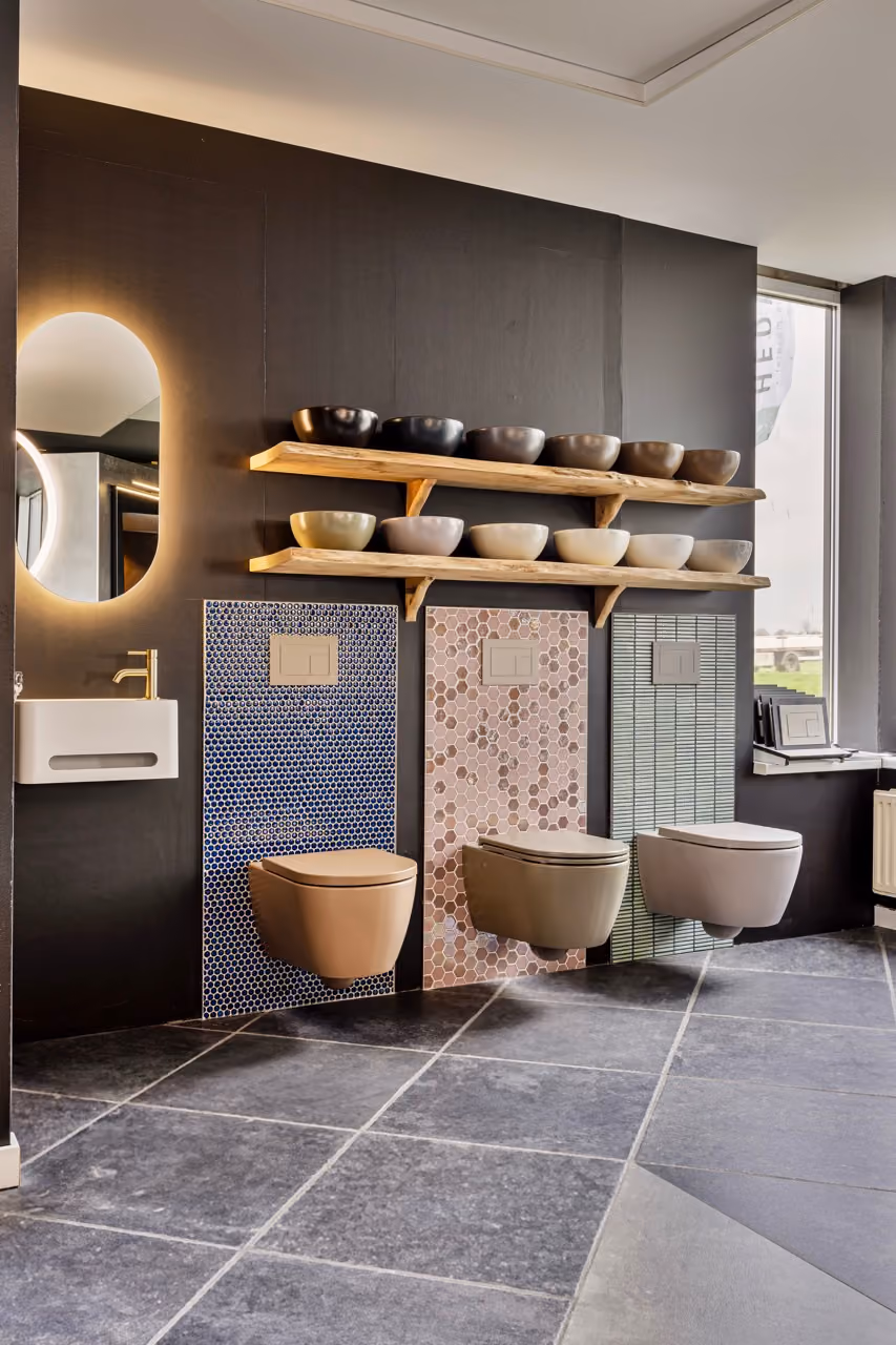 Hangende toiletten met mozaiektegels en waskommen op plank - Showroom Borculo Marboma