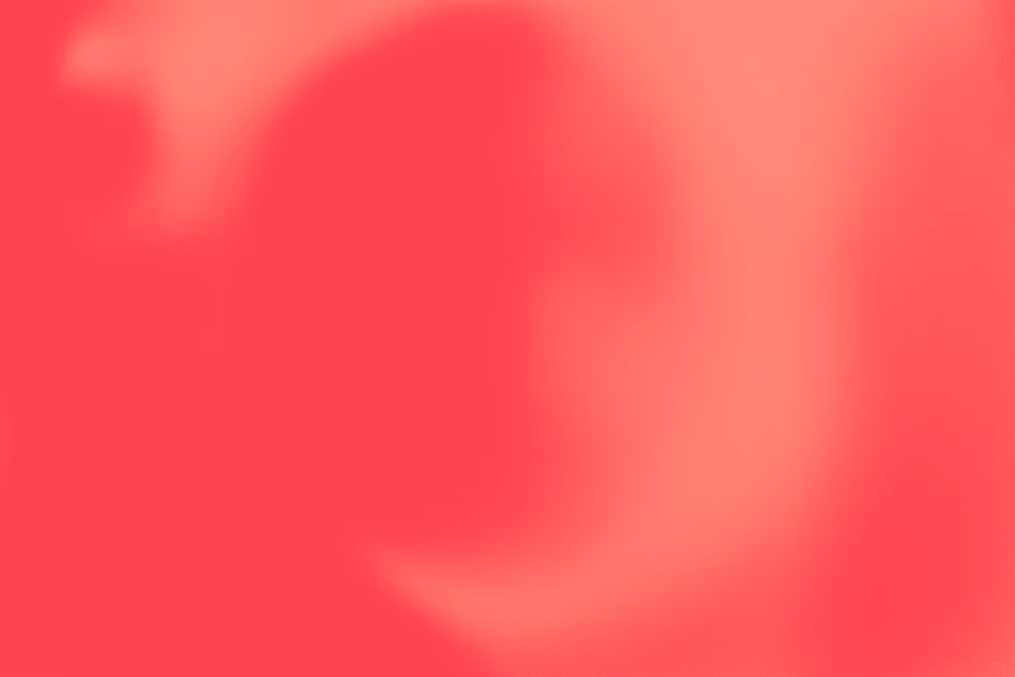 Abstract blend of soft red and pink hues with a misty, blurry texture.