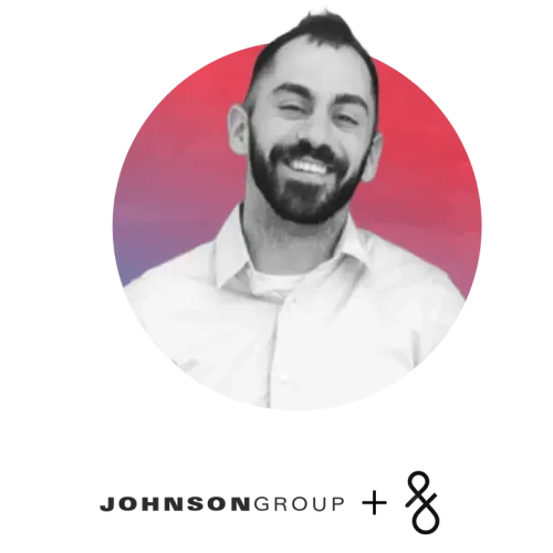 Smiling man with beard wearing a white shirt in front of a red and purple circular background.