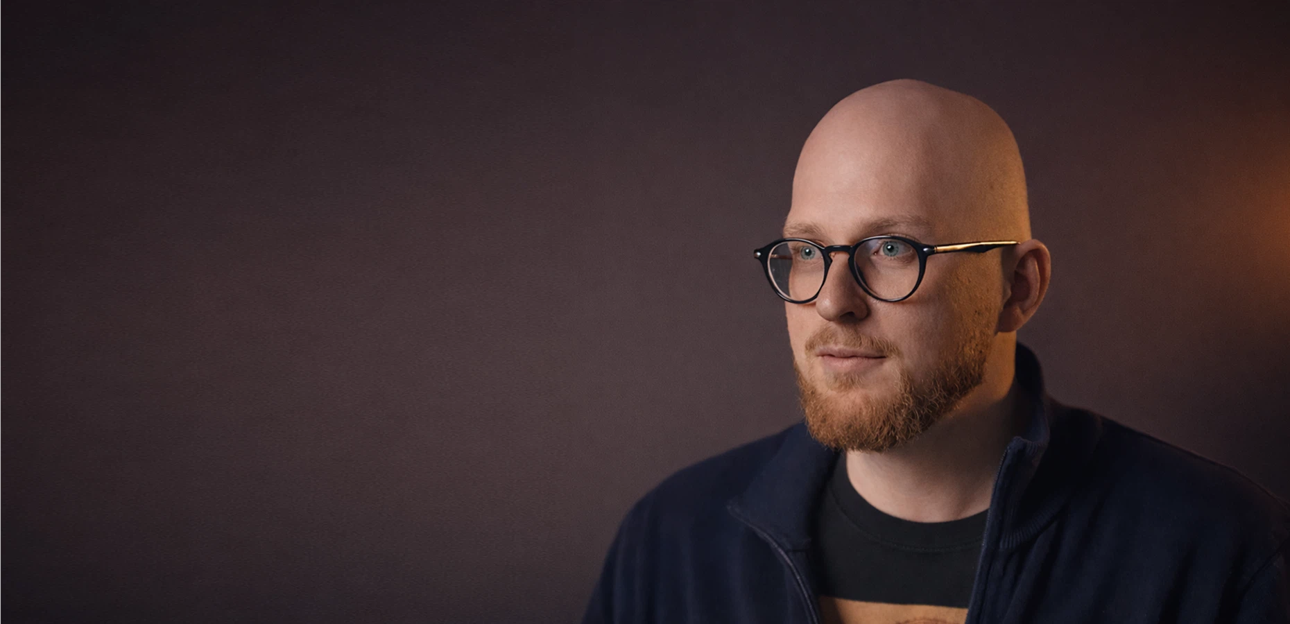 Portrait of Vitalik Vinnikov, Co-founder of V&M, against a dark background