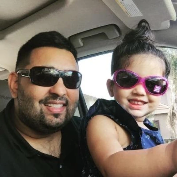 Aman Tamana, the president at Tamana Truck Lines, smiling with his daughter