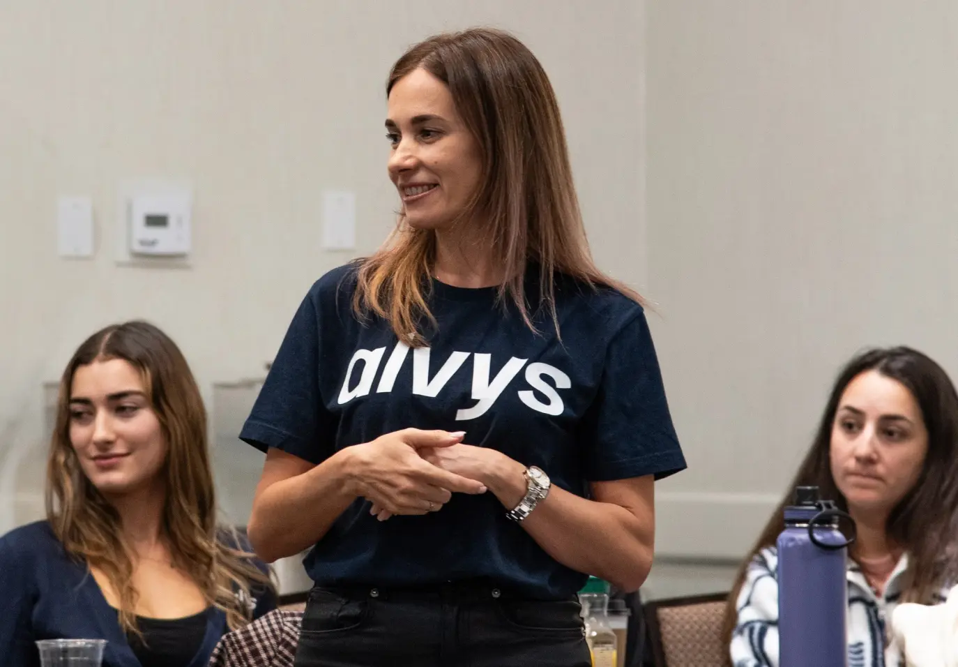 A woman wearing a t-shirt with the word "Alvys"