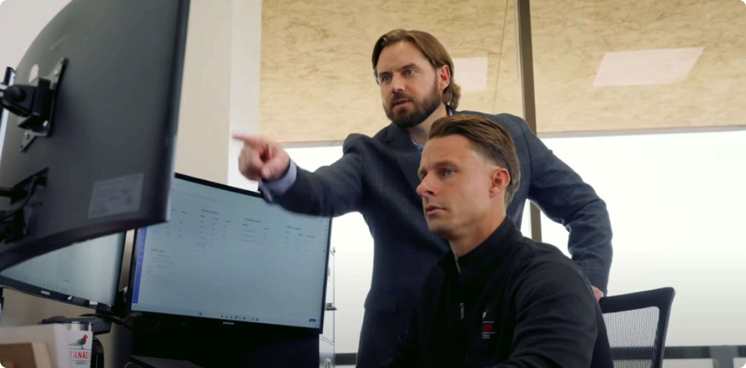two people looking at a computer monitor