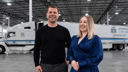 Universe Carrier CEO and Operations Manager laughing standing in front of a truck with an overlay of alvys software
