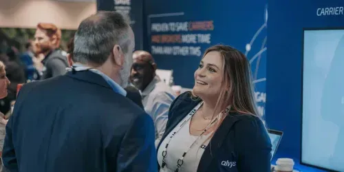 two-people-talking-at-conference-booth