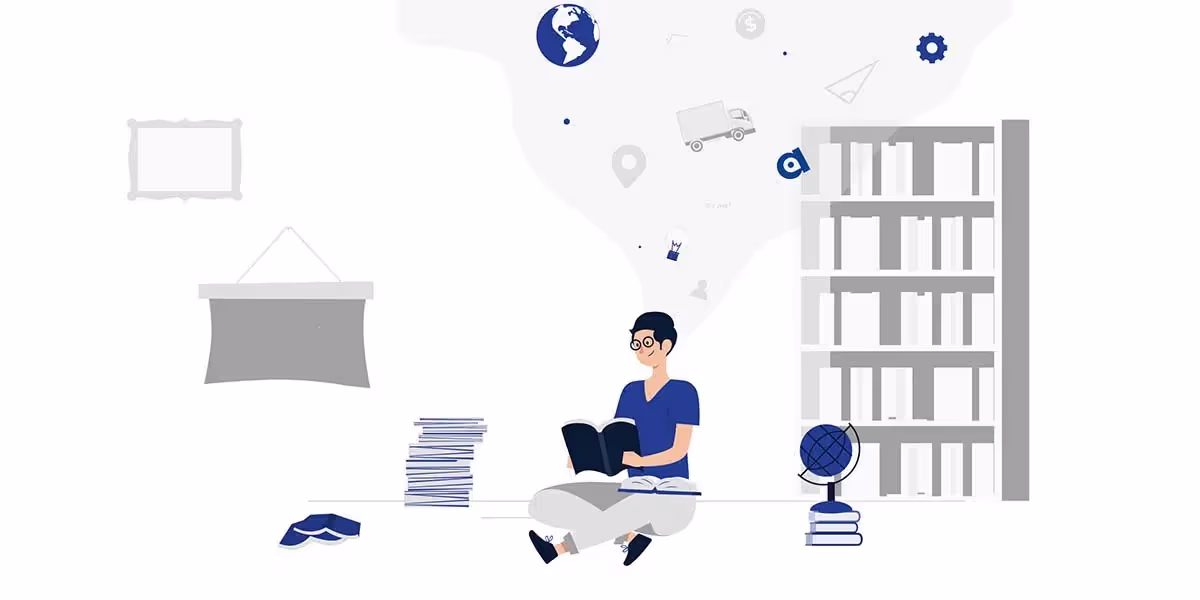 person-sitting-down-researching-with-books-and-computer