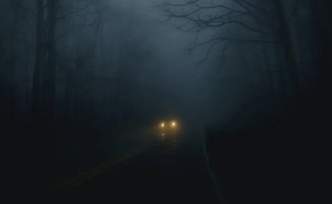 car-driving-down-a-dark-spooky-road