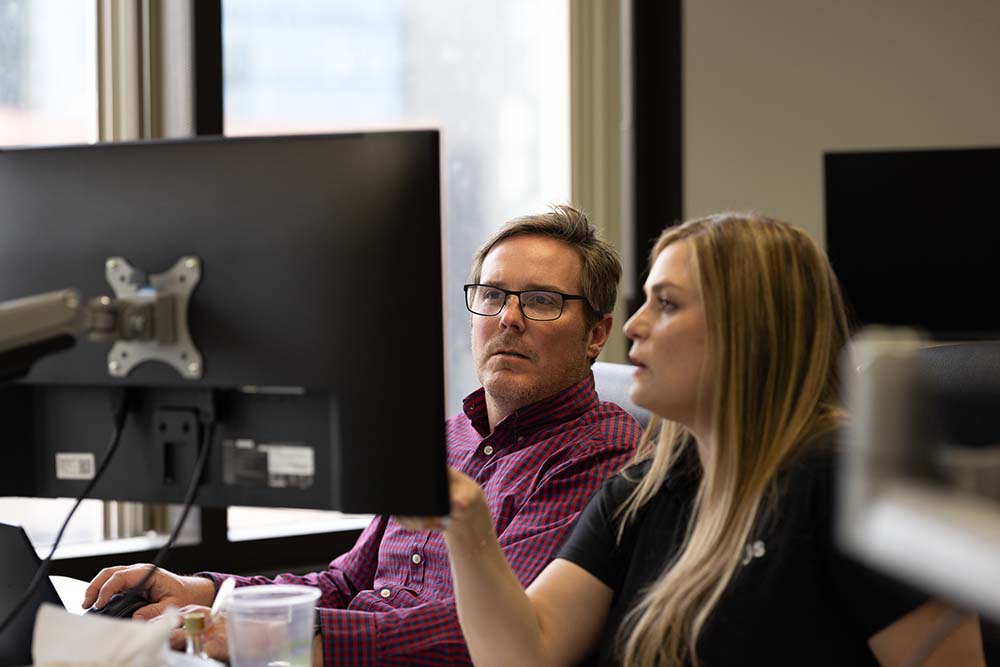 A man and a woman using a computer