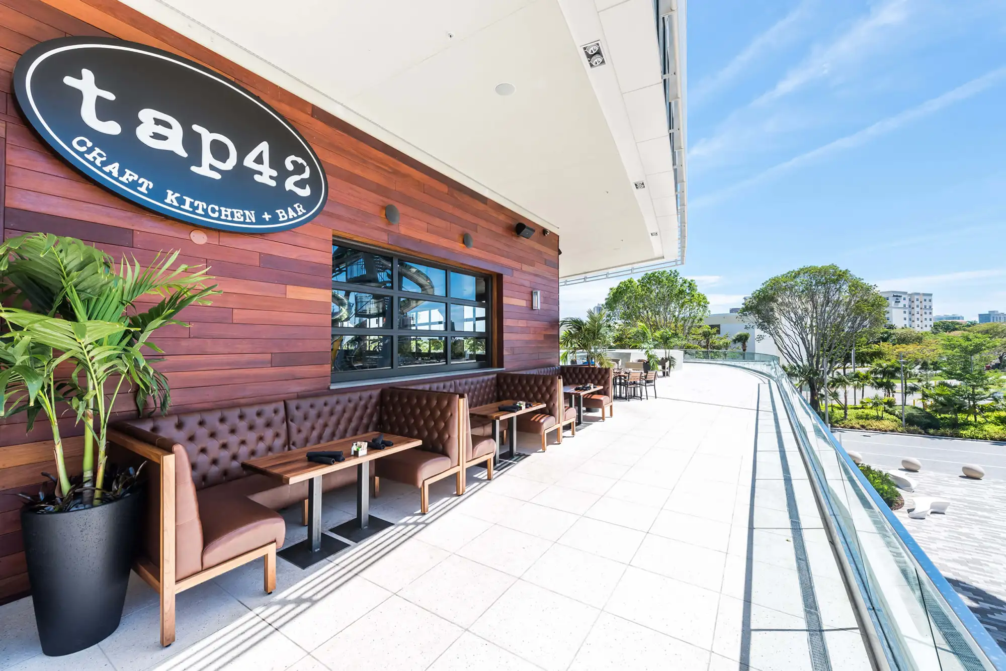 The outdoor terrace seating area of the Tap 42 Craft Kitchen & Bar location at Aventura Mall in Florida. 