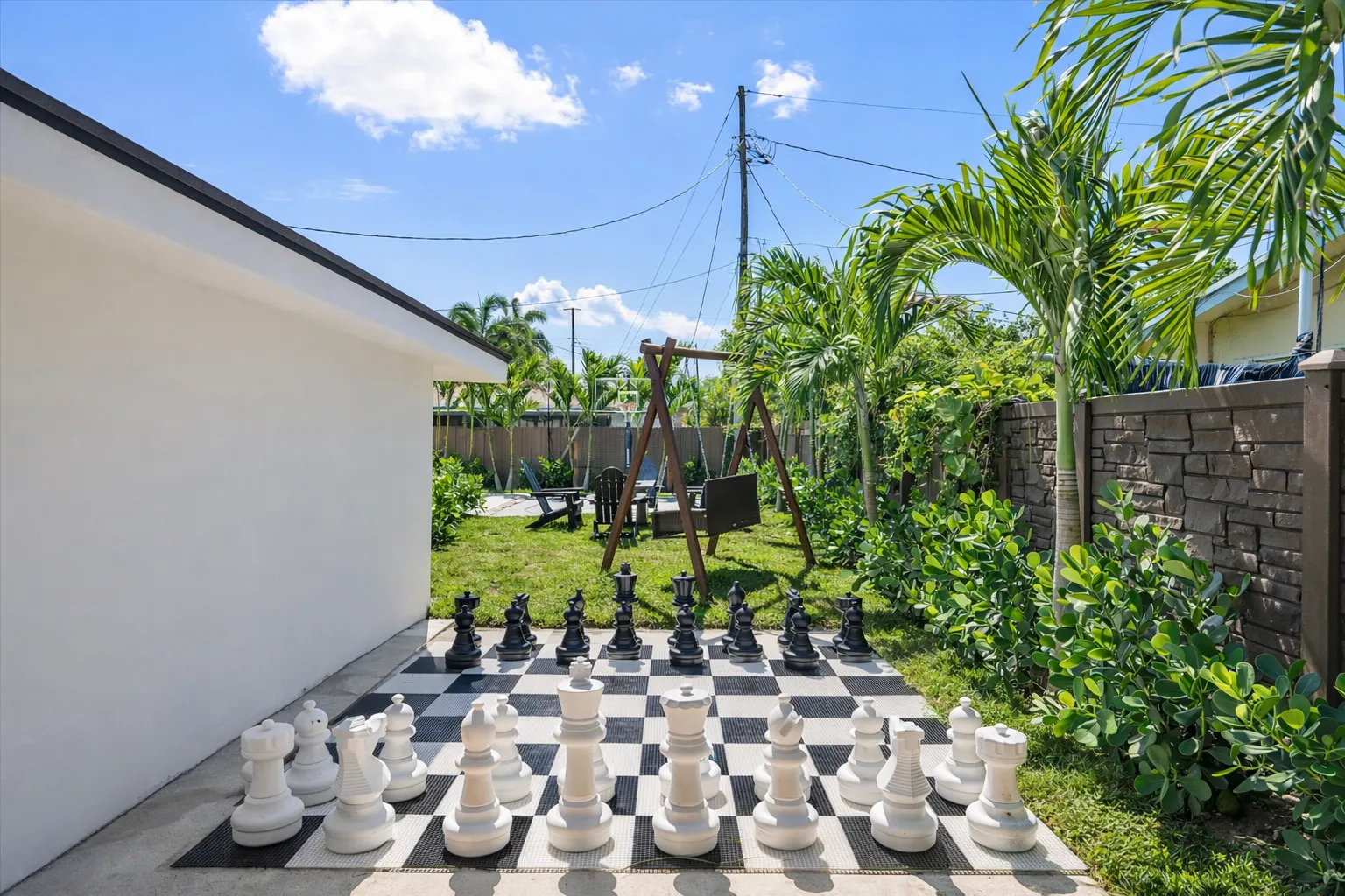 The outdoor of luxury villa, which features a giant chess set and a tropical garden