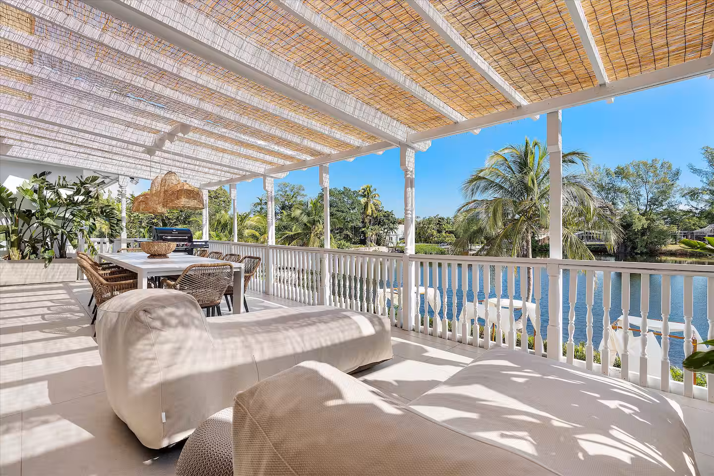 A spacious, sunlit outdoor terrace with a tropical, coastal vibe