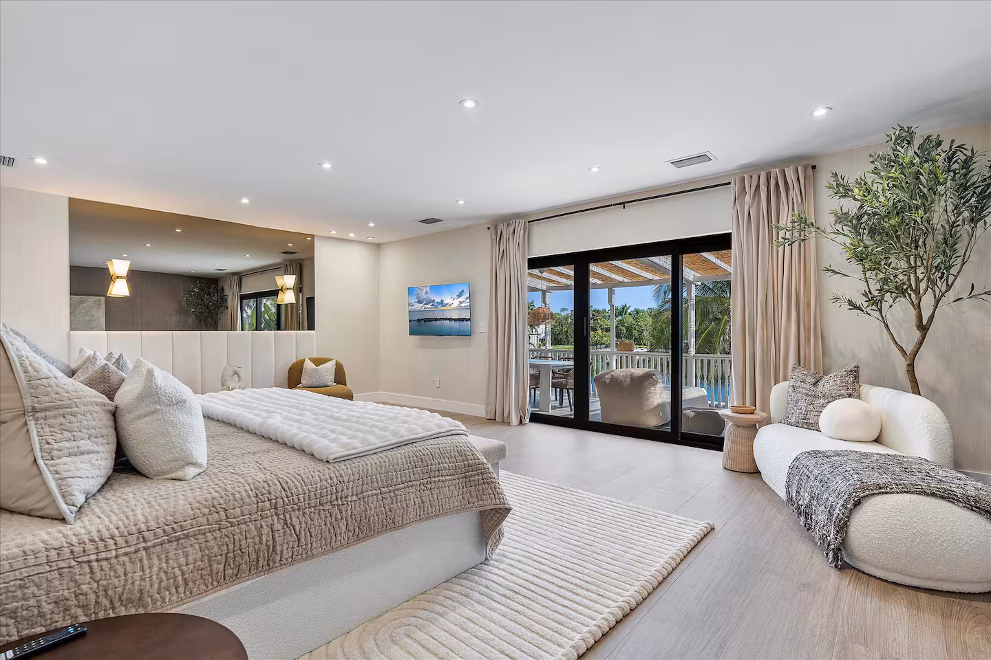 A luxurious modern master bedroom in a Miami lakefront mansion. 