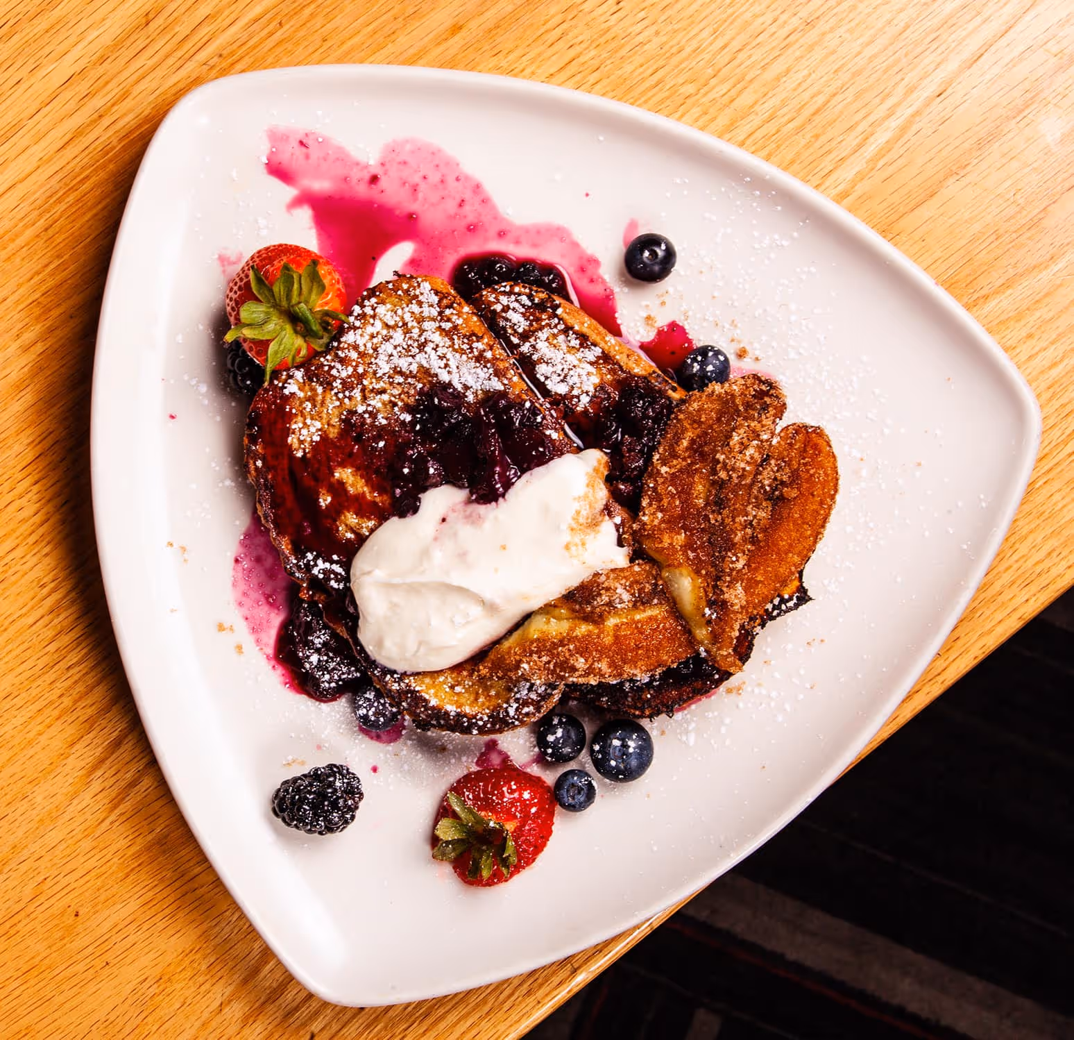 A plate of food with a blueberry on top.