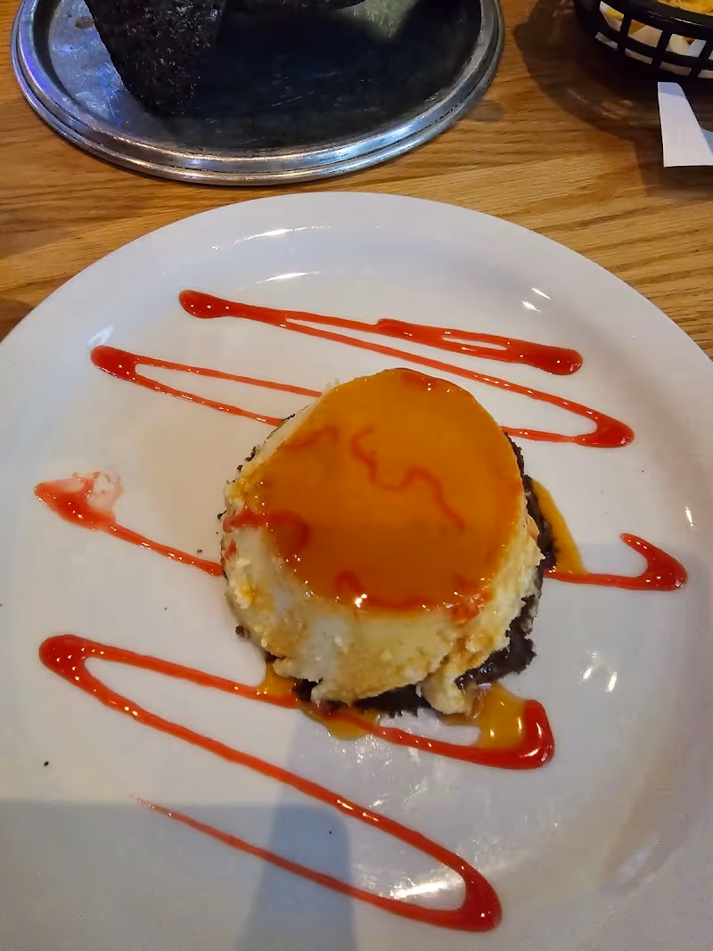 A white plate with a slice of cake on it.