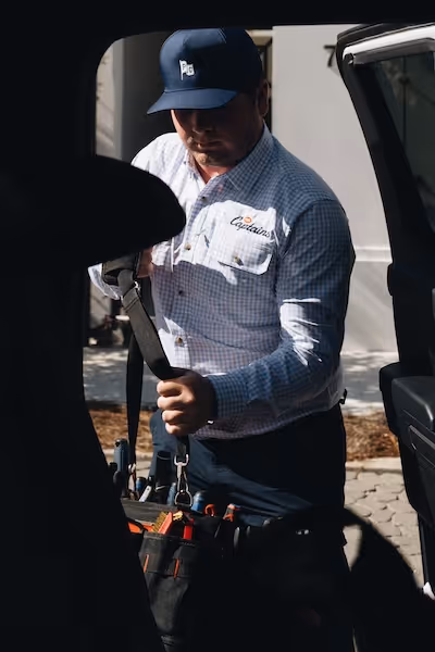Pool Captains employee loading a toolkit into a vehicle.