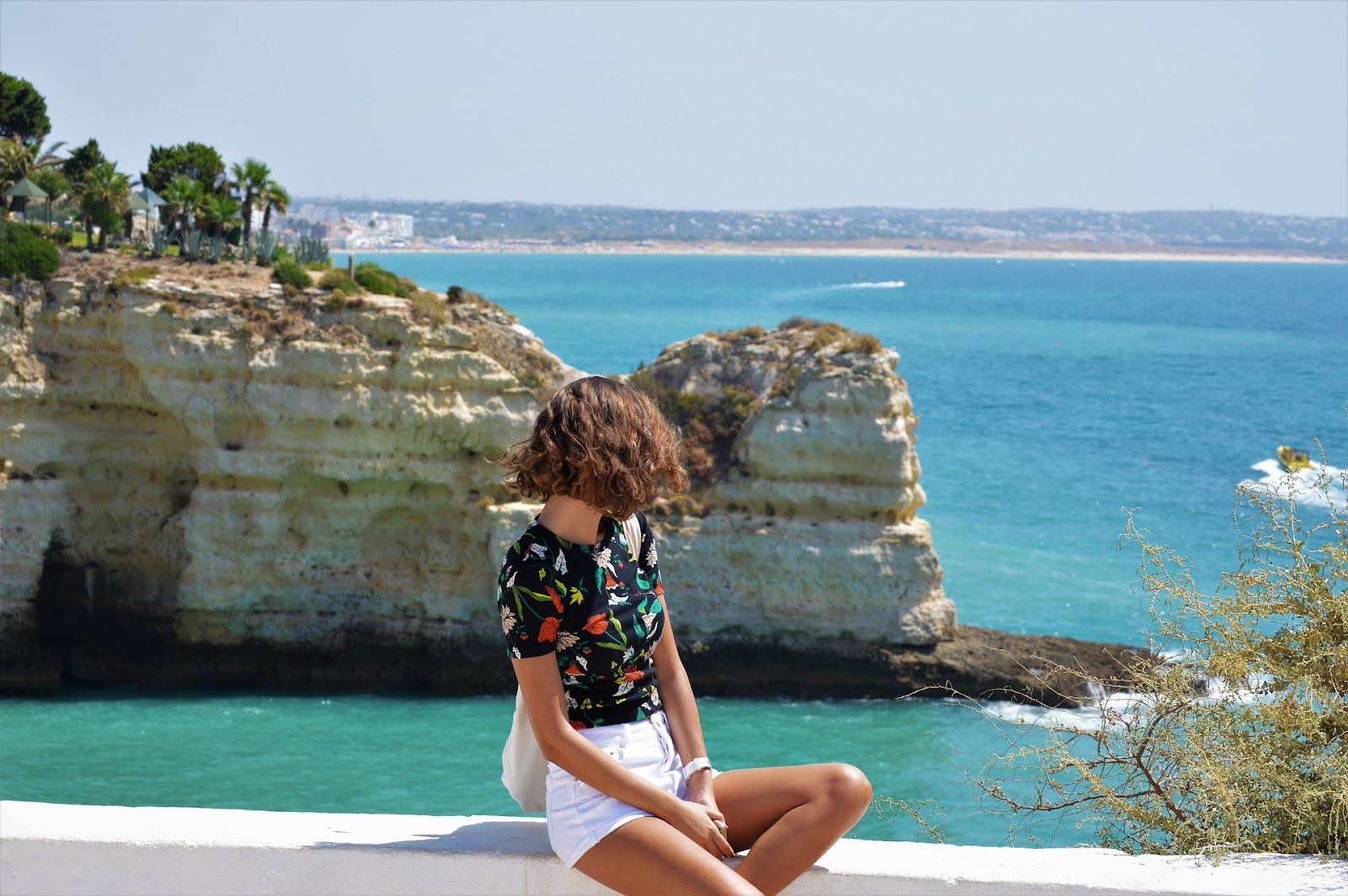 Young woman overlooking seaside cliffs