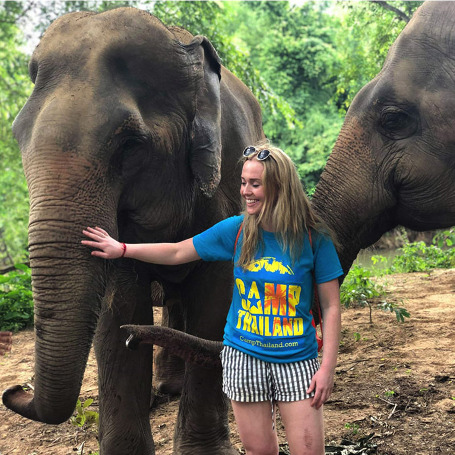 Camp participant spends time with two elephants at an elephant sanctuary