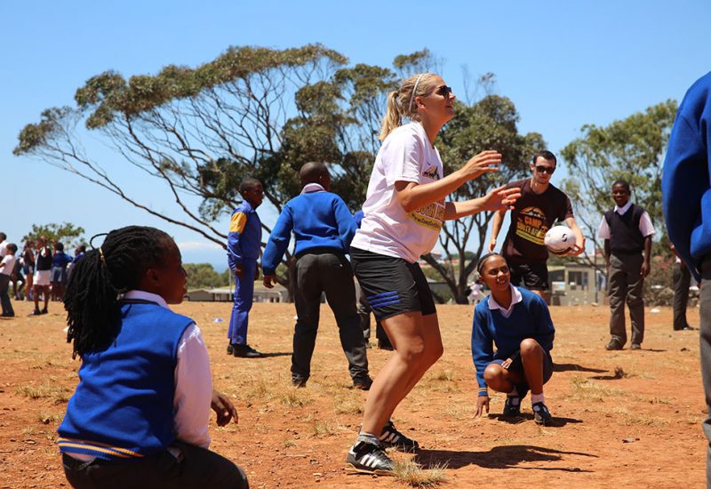 Camp participants coach sports to a group of kids in South Africa.