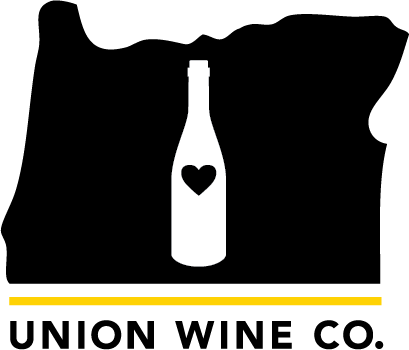 Logo of Union Wine Co. featuring a bottle with a heart inside, overlaid on the shape of Oregon state with a yellow horizontal line.