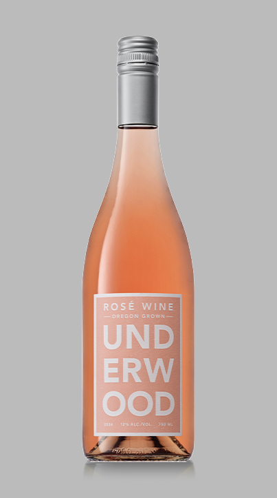 Bottle of Underwood Rosé Wine from Oregon with a silver cap and pinkish-orange wine inside.