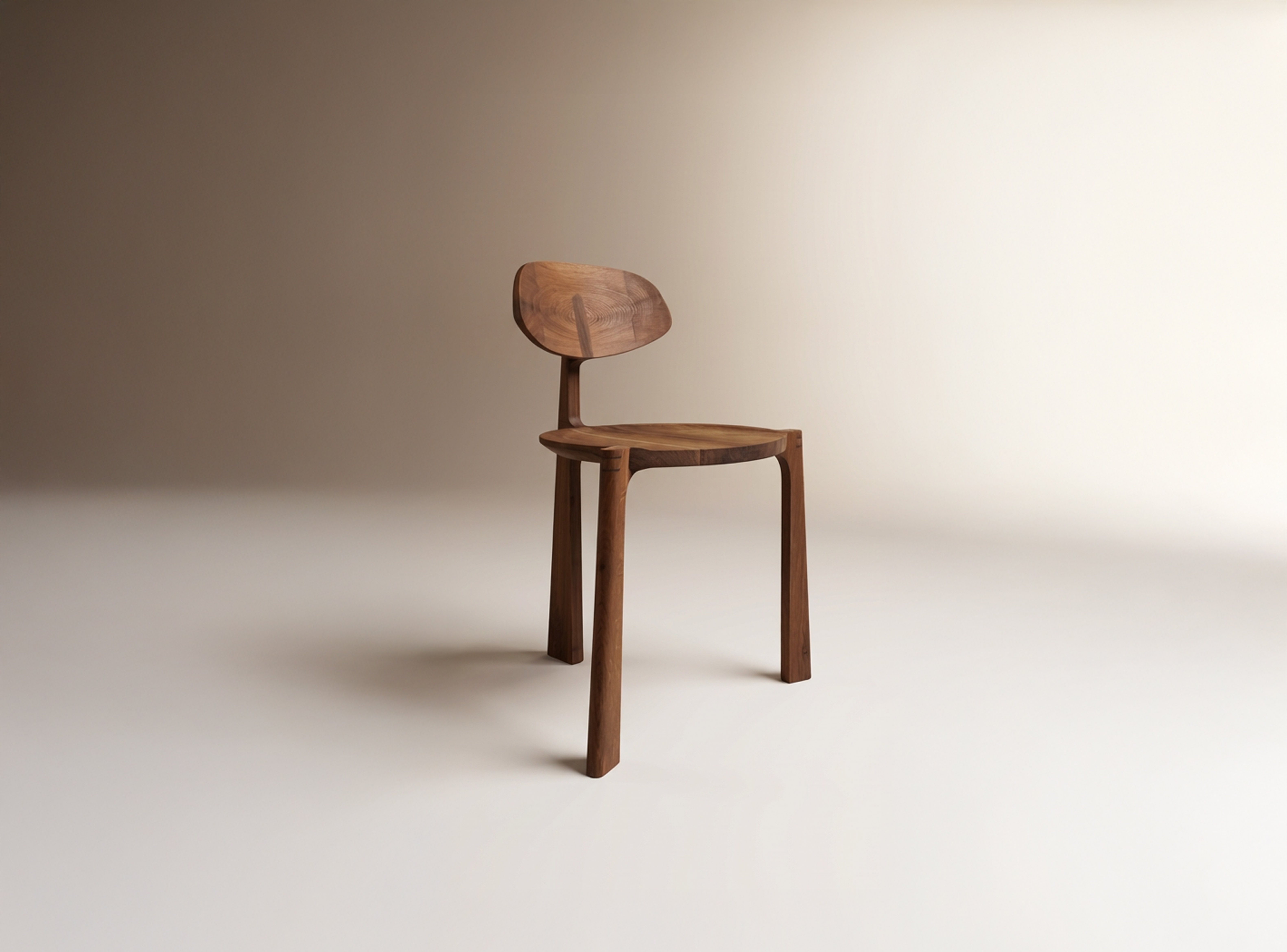 Minimalist wooden chair with curved backrest and round seat on a neutral beige background.