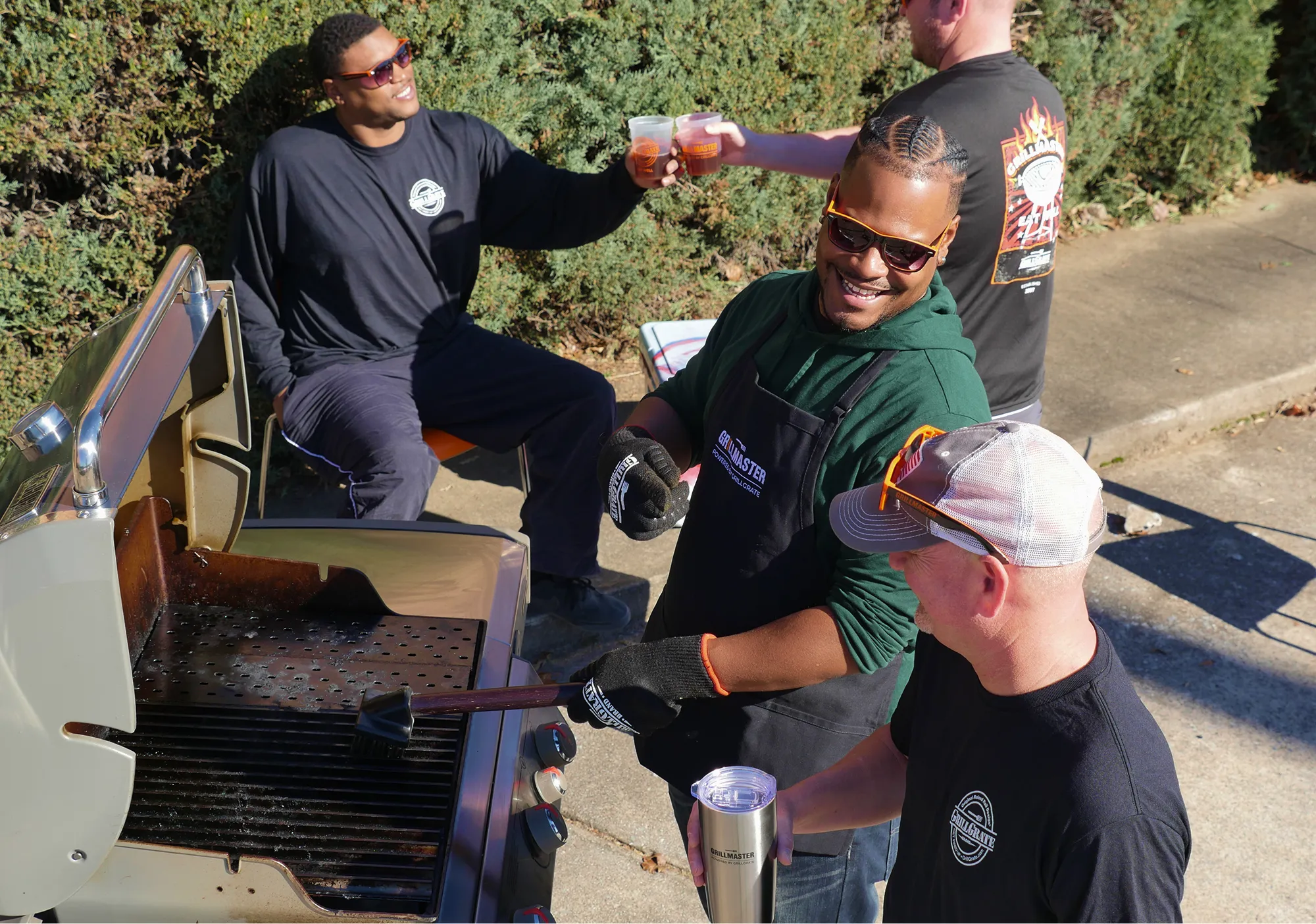Hakim Callendar of GrillGrate in a lifestyle photoshoot with friends around a grill